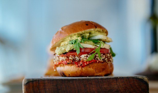 Plant-based burger with fresh greens and tomato